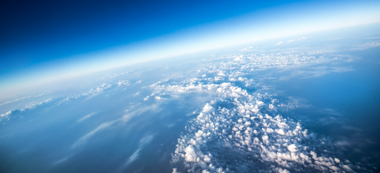 High-altitude view of Earth showing cloud-covered surface.