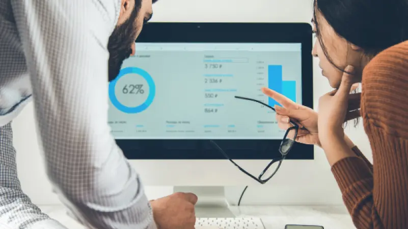Man and woman checking data in a dashboard