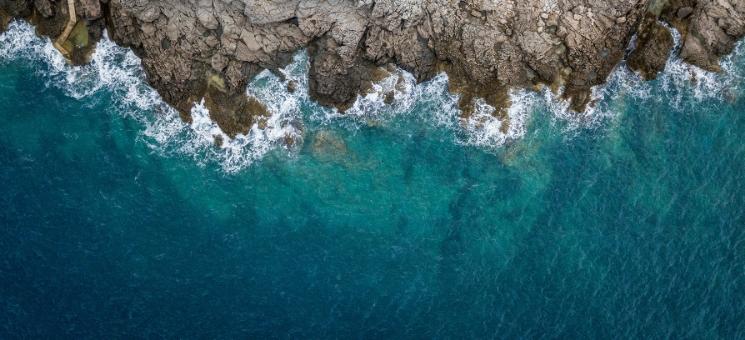 aerial view of the ocean and a cliff