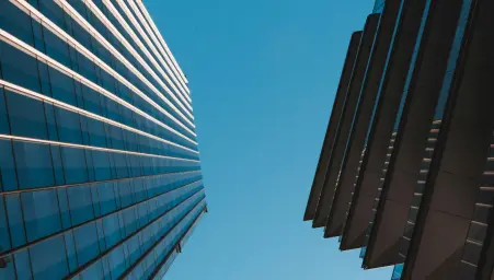 Two skyscrapers showed from above, under a blue sky