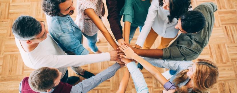 A group of diverse people joining hands