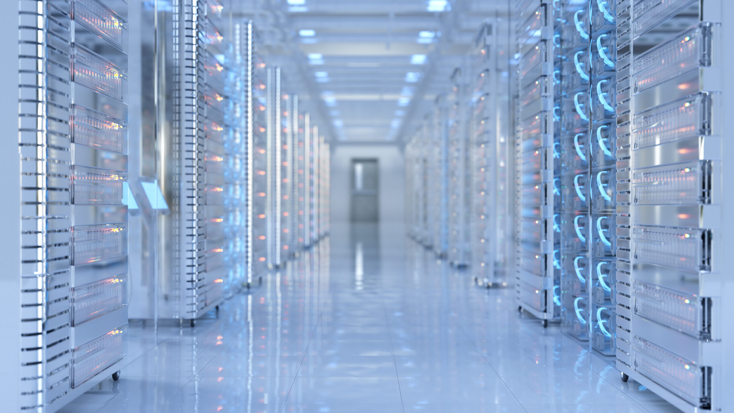 Modern data center with rows of illuminated server racks and reflective flooring under bright overhead lighting.
