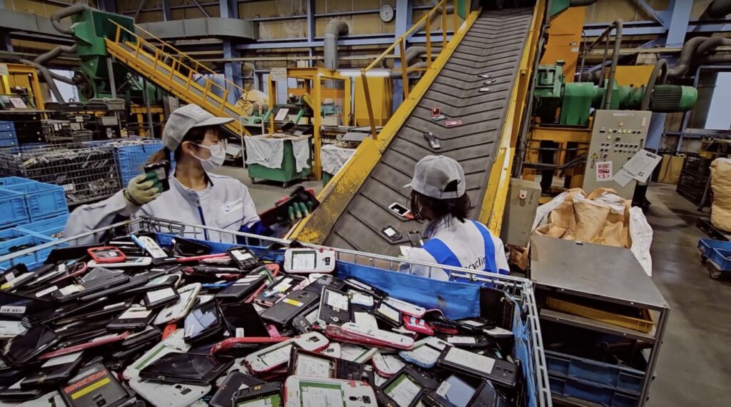 Employees working recycling mobile phones
