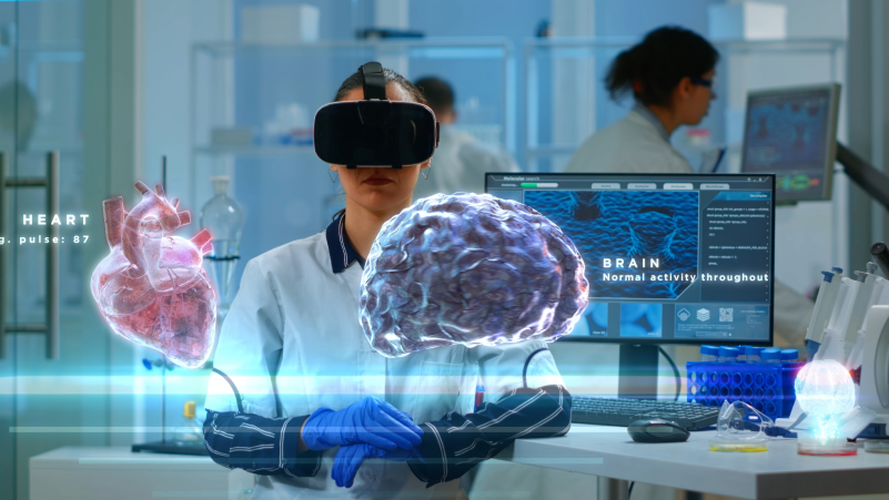 person in a lab using virtual reality to review the status of a virtual heart and a virtual brain