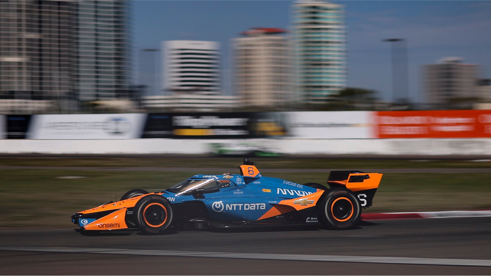 NTT DATA-sponsored race car speeding through track.