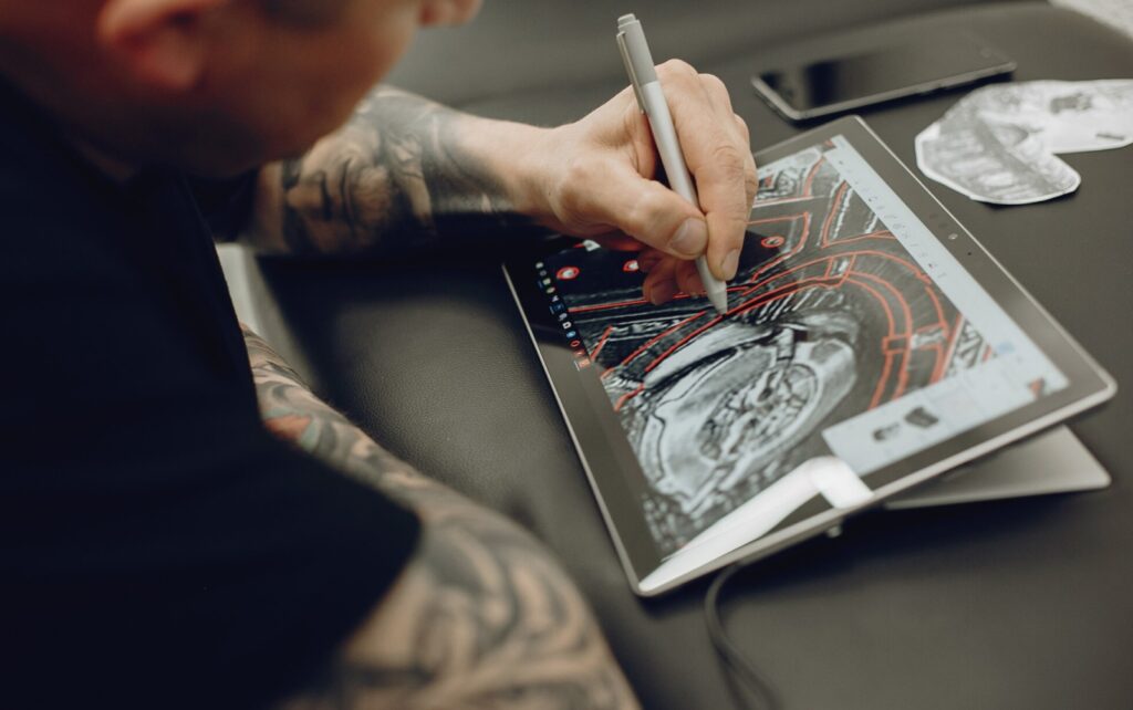 man creating a digital design in his tablet