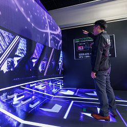 NTT employee playing with some interactive screens and floor