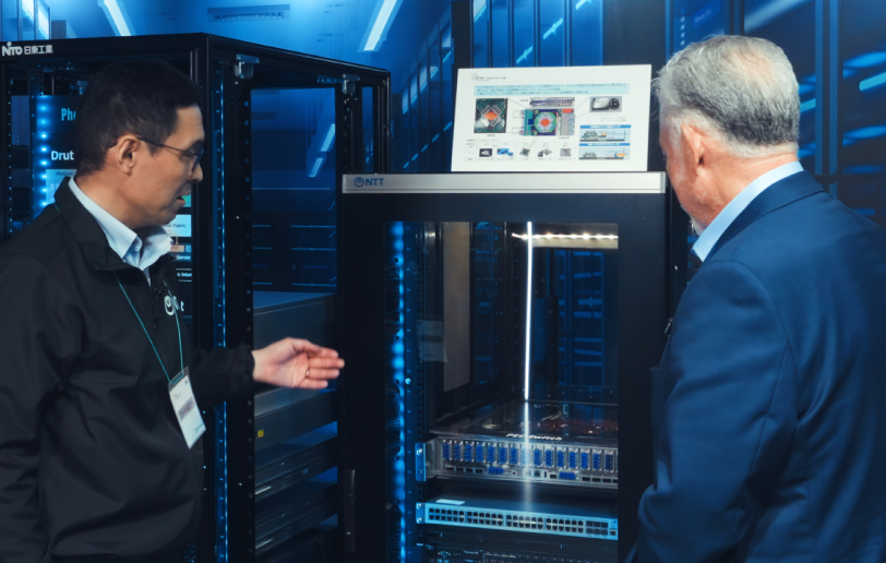 Dr. Norio Sato, Group Leader Device Innovation Center, NTT, Inc., showing a hardware device for optical engines